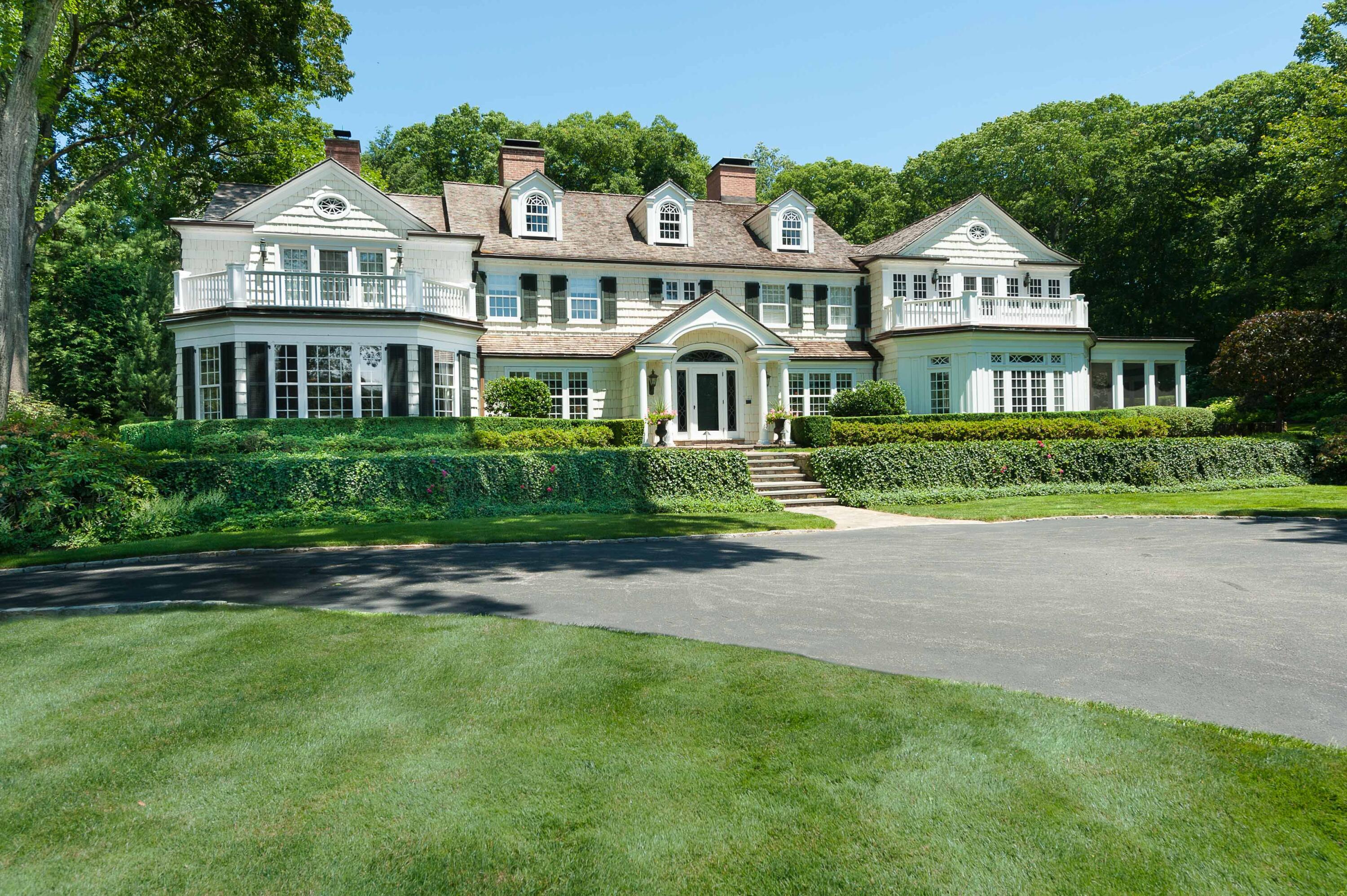 707 West Road New Canaan, CT 06840 - Photo 1 of 58 a front view of a house with a garden