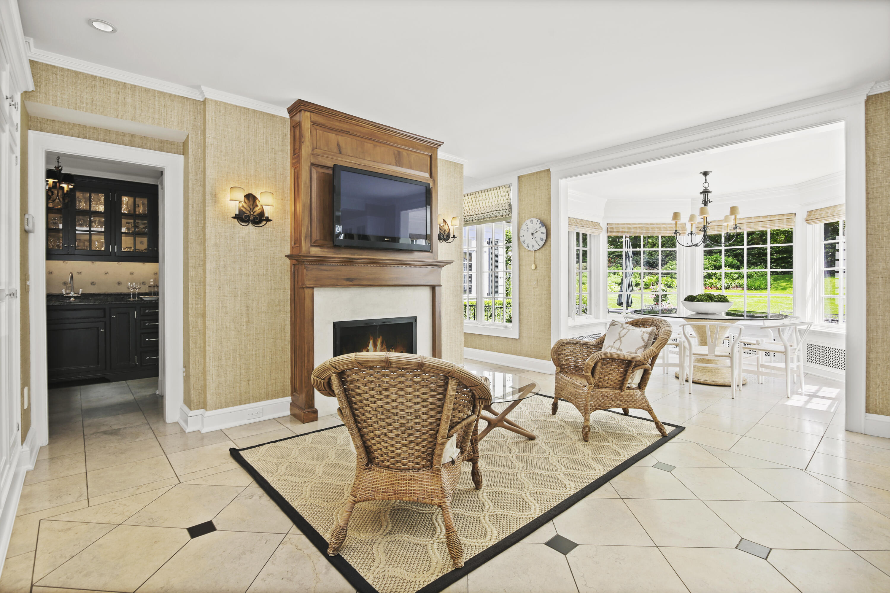 707 West Road New Canaan, CT 06840 - Photo 23 of 58 a living room with furniture a flat screen tv and a fireplace
