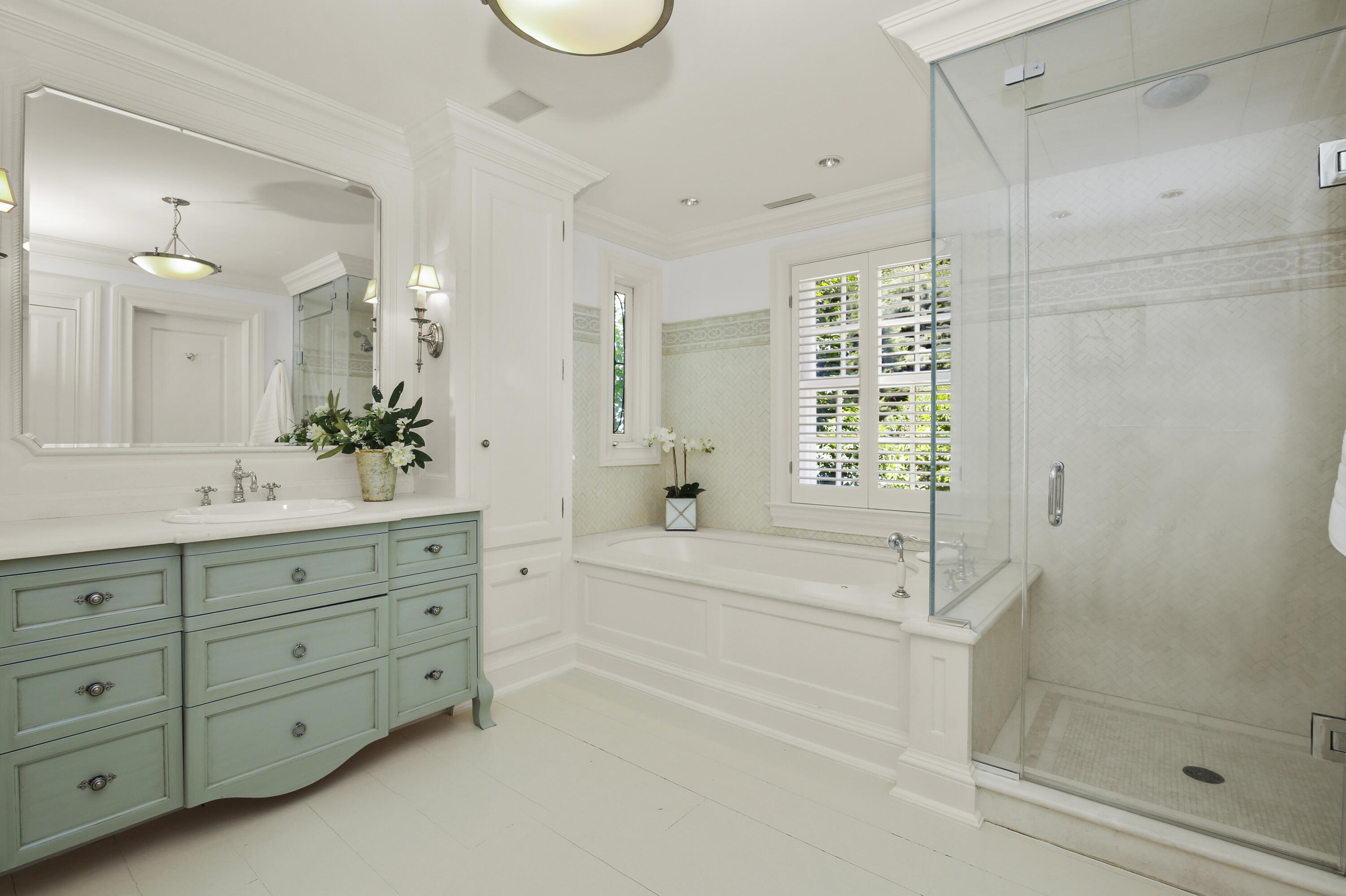 707 West Road New Canaan, CT 06840 - Photo 35 of 58 a bathroom with a double vanity sink a large mirror a shower and bathtub