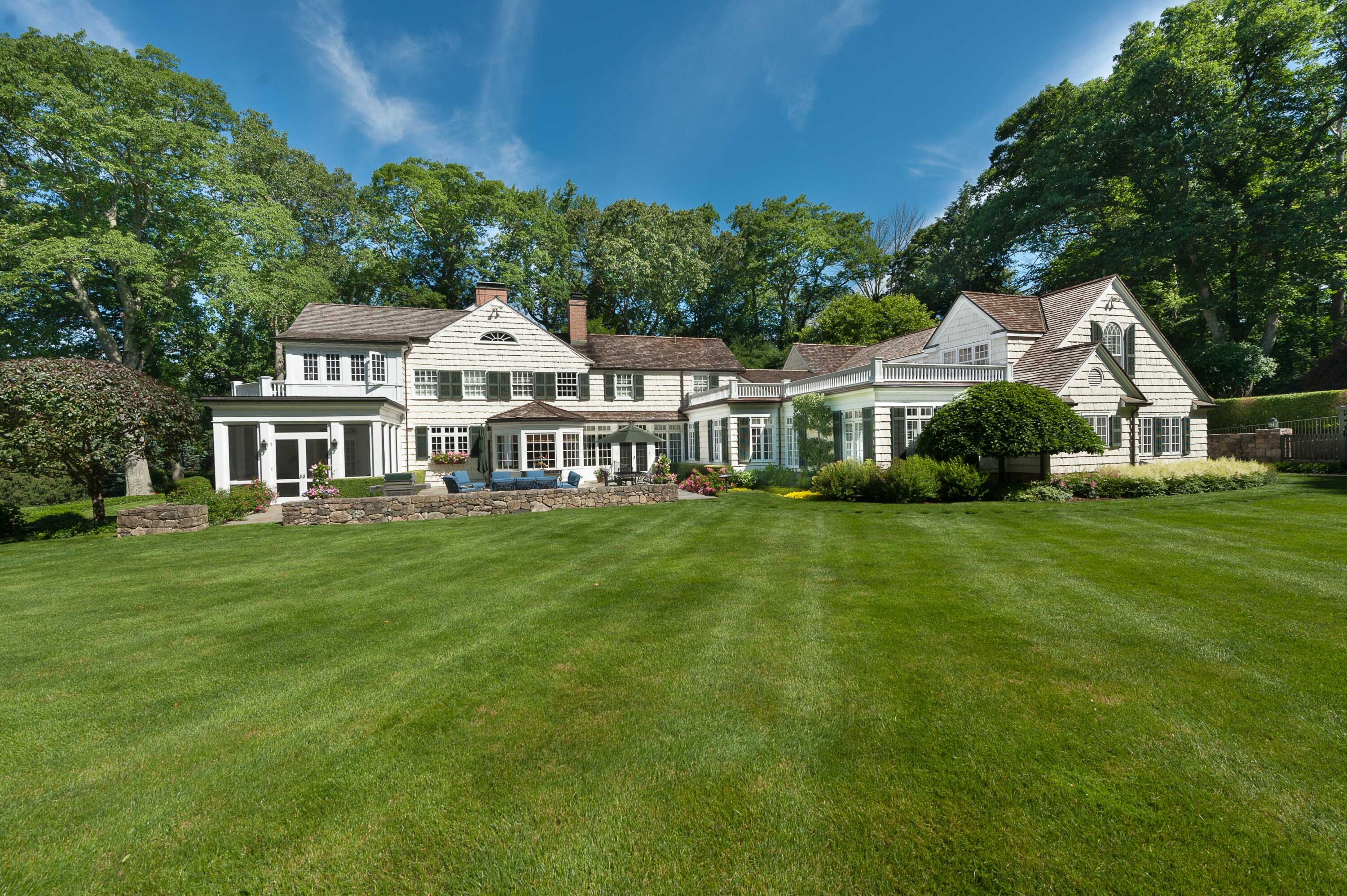 707 West Road New Canaan, CT 06840 - Photo 4 of 58 a front view of a house with a garden