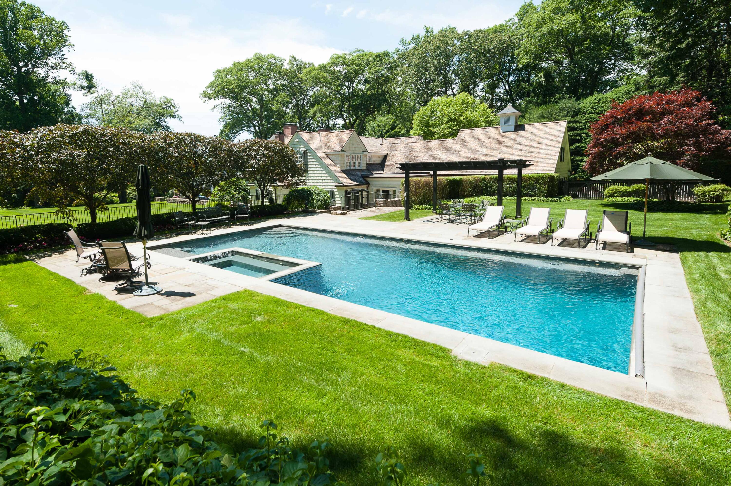707 West Road New Canaan, CT 06840 - Photo 5 of 58 a view of a house with pool lawn chairs and a yard