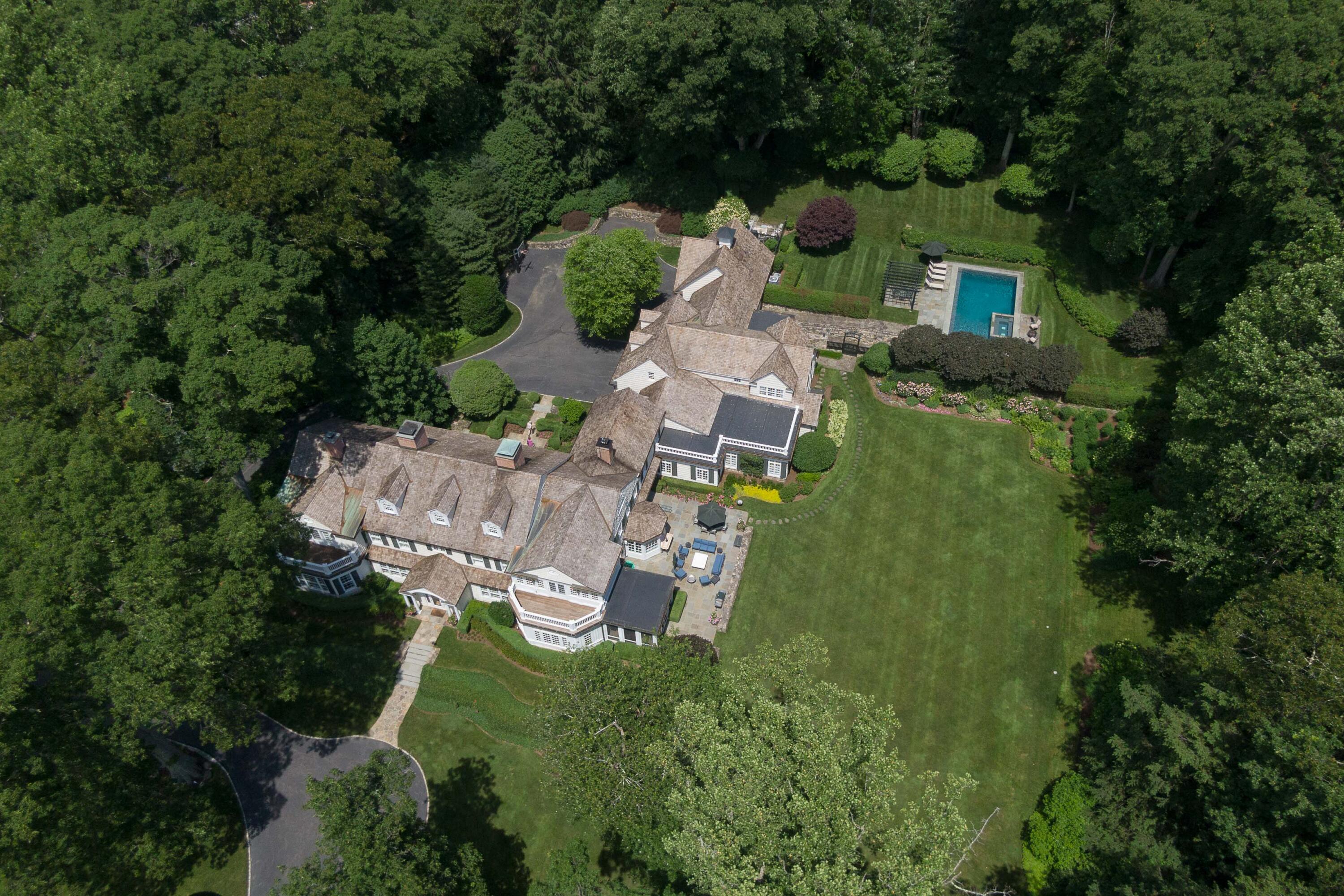 707 West Road New Canaan, CT 06840 - Photo 55 of 58 an aerial view of a house with outdoor space pool patio outdoor seating and yard