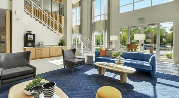 a living room with furniture and a floor to ceiling window