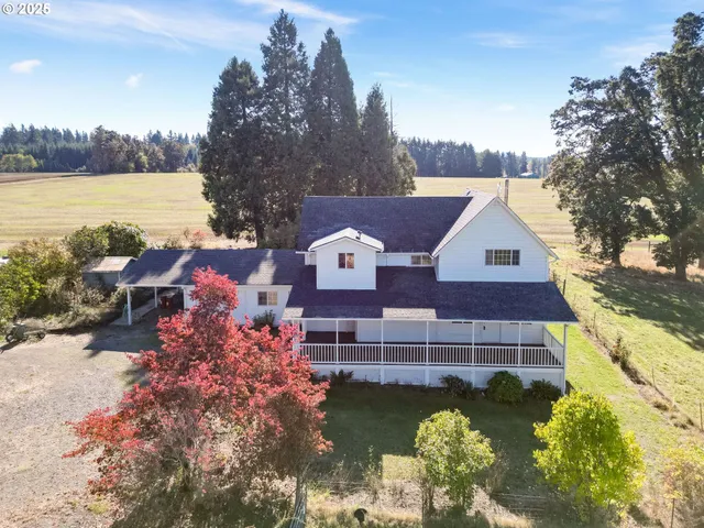 a aerial view of a house with a yard and lake view