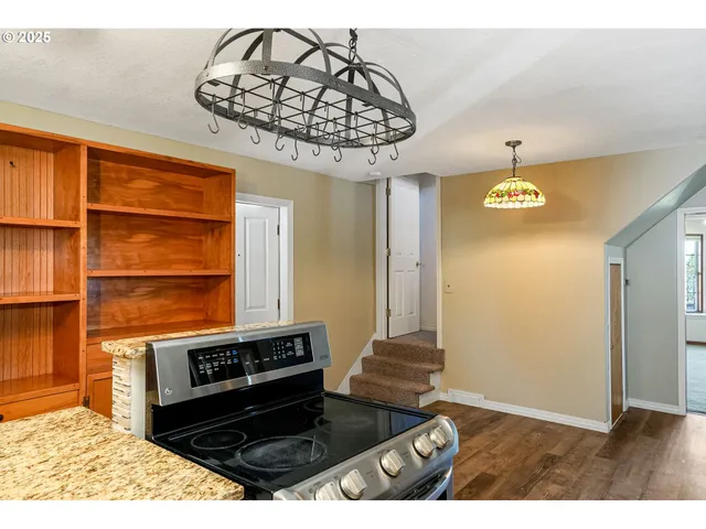 a kitchen with a stove and a chandelier