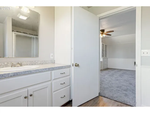 a bathroom with a granite countertop sink mirror and vanity