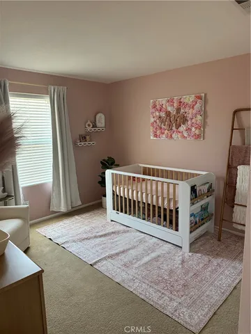 a view of a bedroom with wooden floor and a window