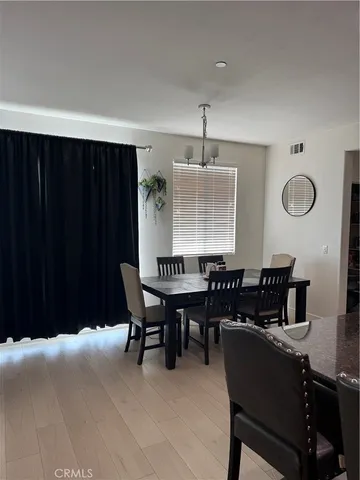 a dining room with furniture and chandelier