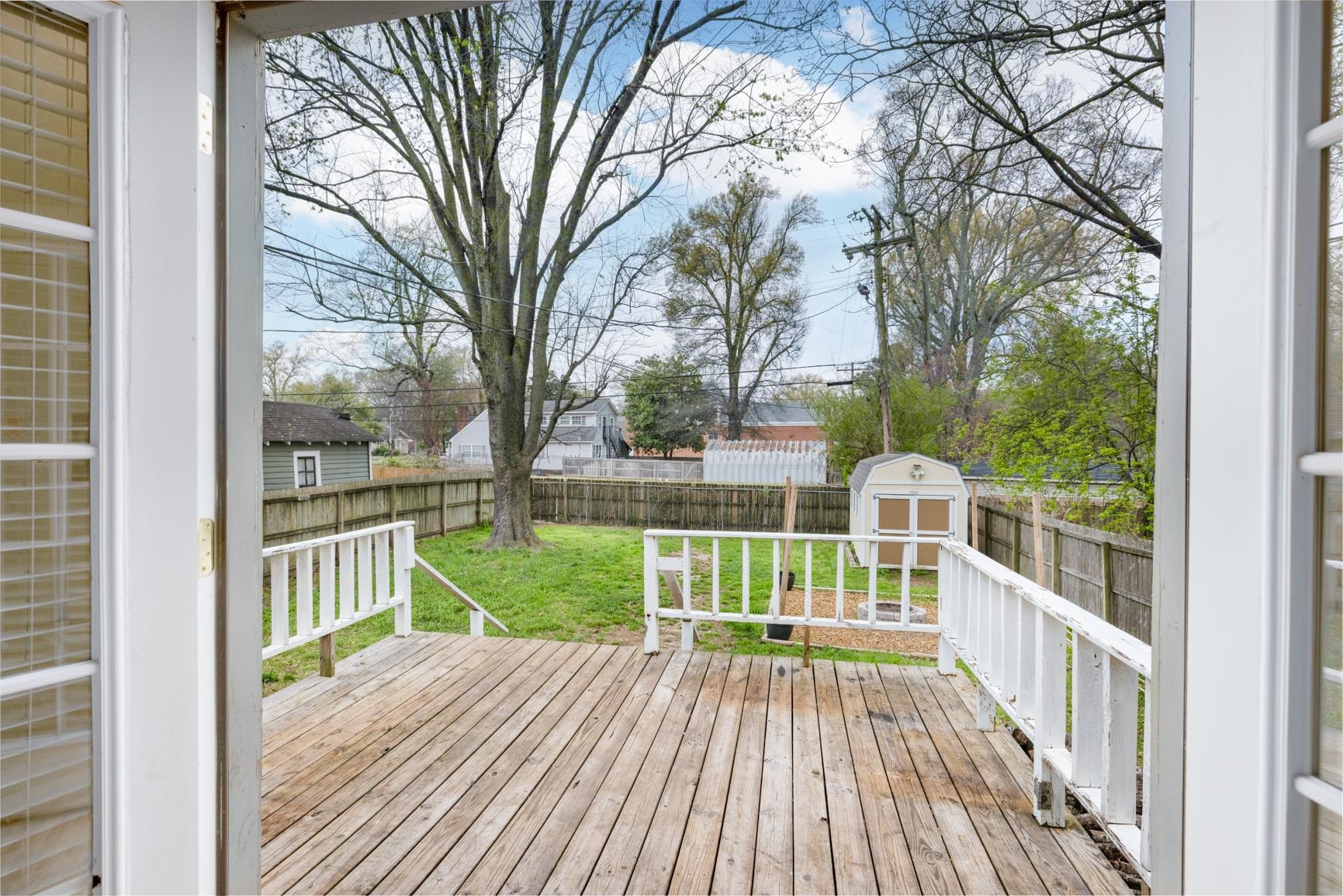 331 Alexander Street Memphis, TN 38111 - Photo 23 of 25 Wooden terrace with a storage unit and a fenced backyard