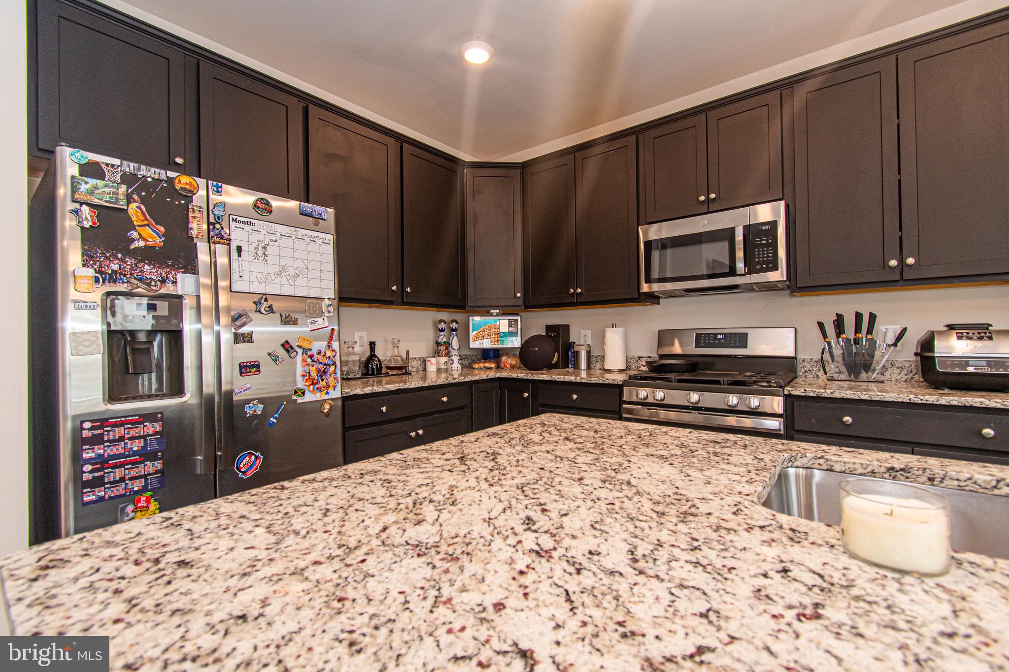 9637 Block Street Lanham, MD 20706 - Photo 14 of 47 a kitchen with stainless steel appliances granite countertop a refrigerator stove and sink