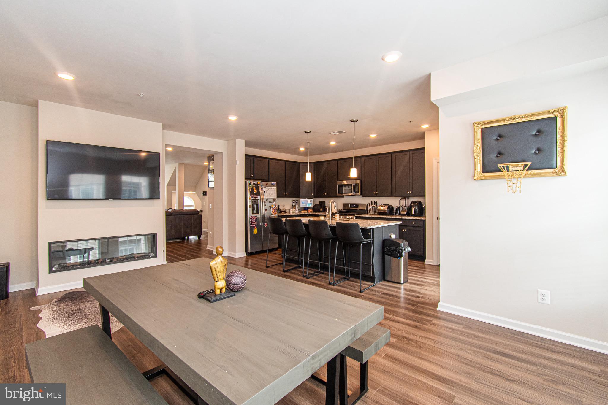 9637 Block Street Lanham, MD 20706 - Photo 15 of 47 a living room with stainless steel appliances kitchen island granite countertop furniture and wooden floor