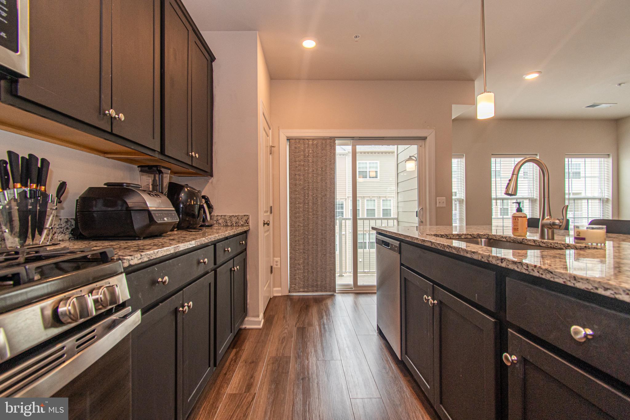 9637 Block Street Lanham, MD 20706 - Photo 22 of 47 a kitchen with stainless steel appliances a sink stove and cabinets