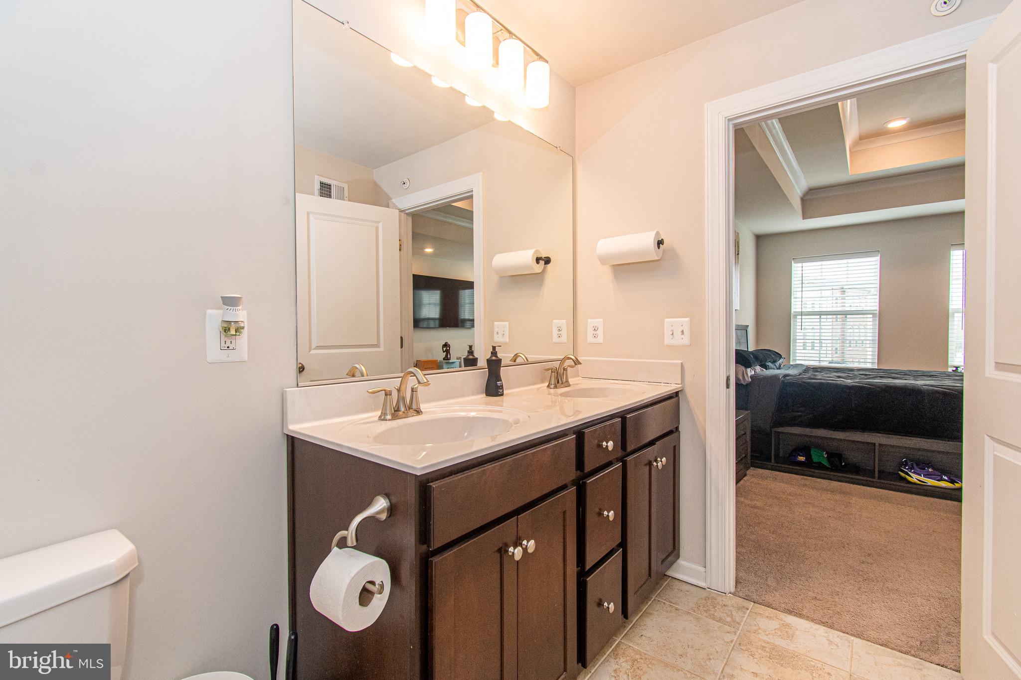 9637 Block Street Lanham, MD 20706 - Photo 26 of 47 a bathroom with a sink a toilet and a mirror