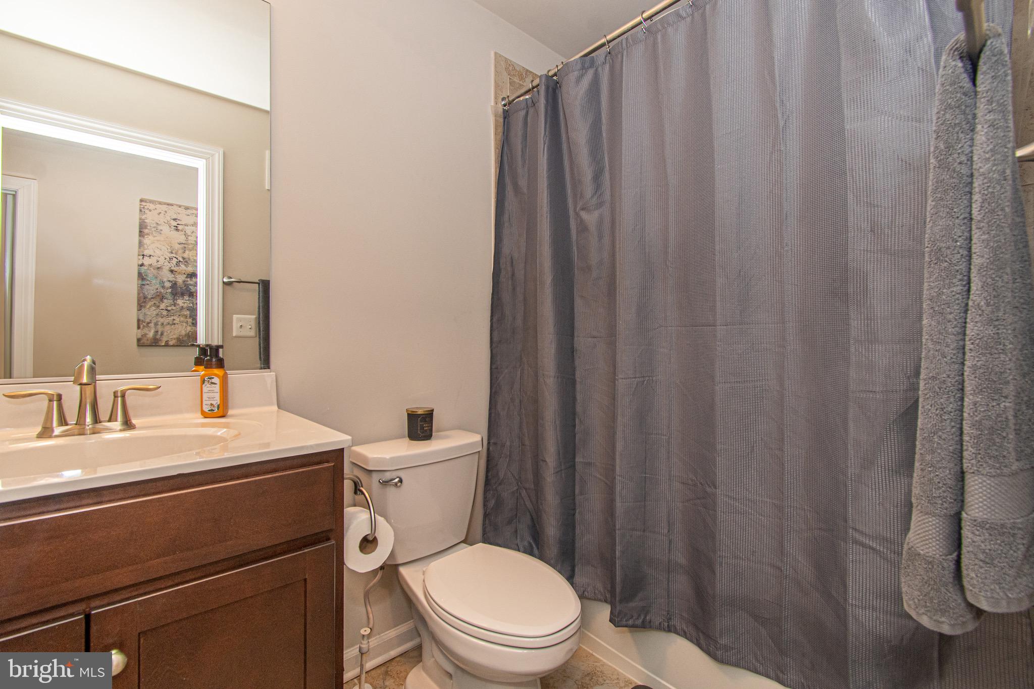 9637 Block Street Lanham, MD 20706 - Photo 28 of 47 a bathroom with a toilet a sink and a shower