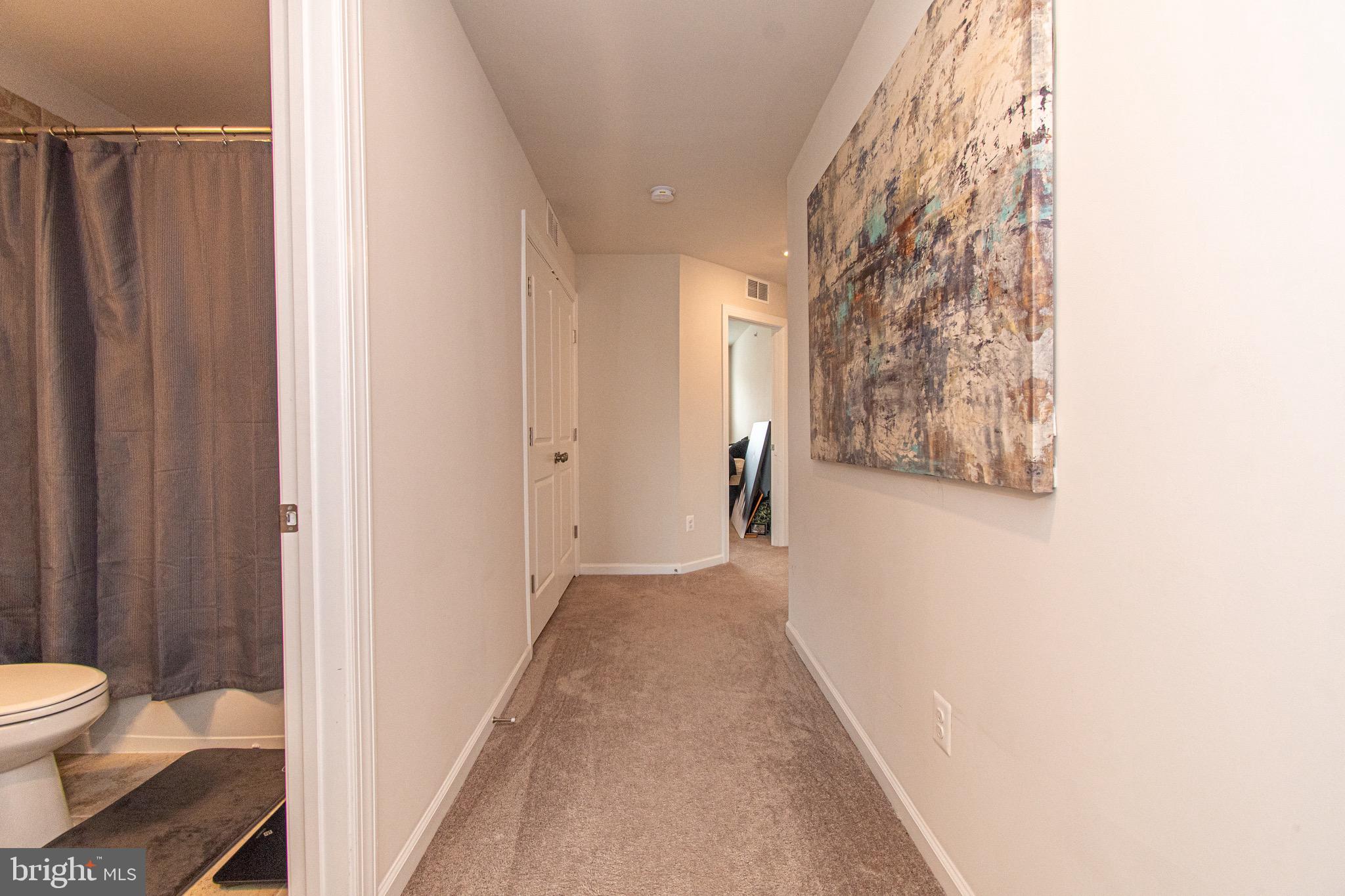 9637 Block Street Lanham, MD 20706 - Photo 30 of 47 a view of a hallway with toilet and a curtain