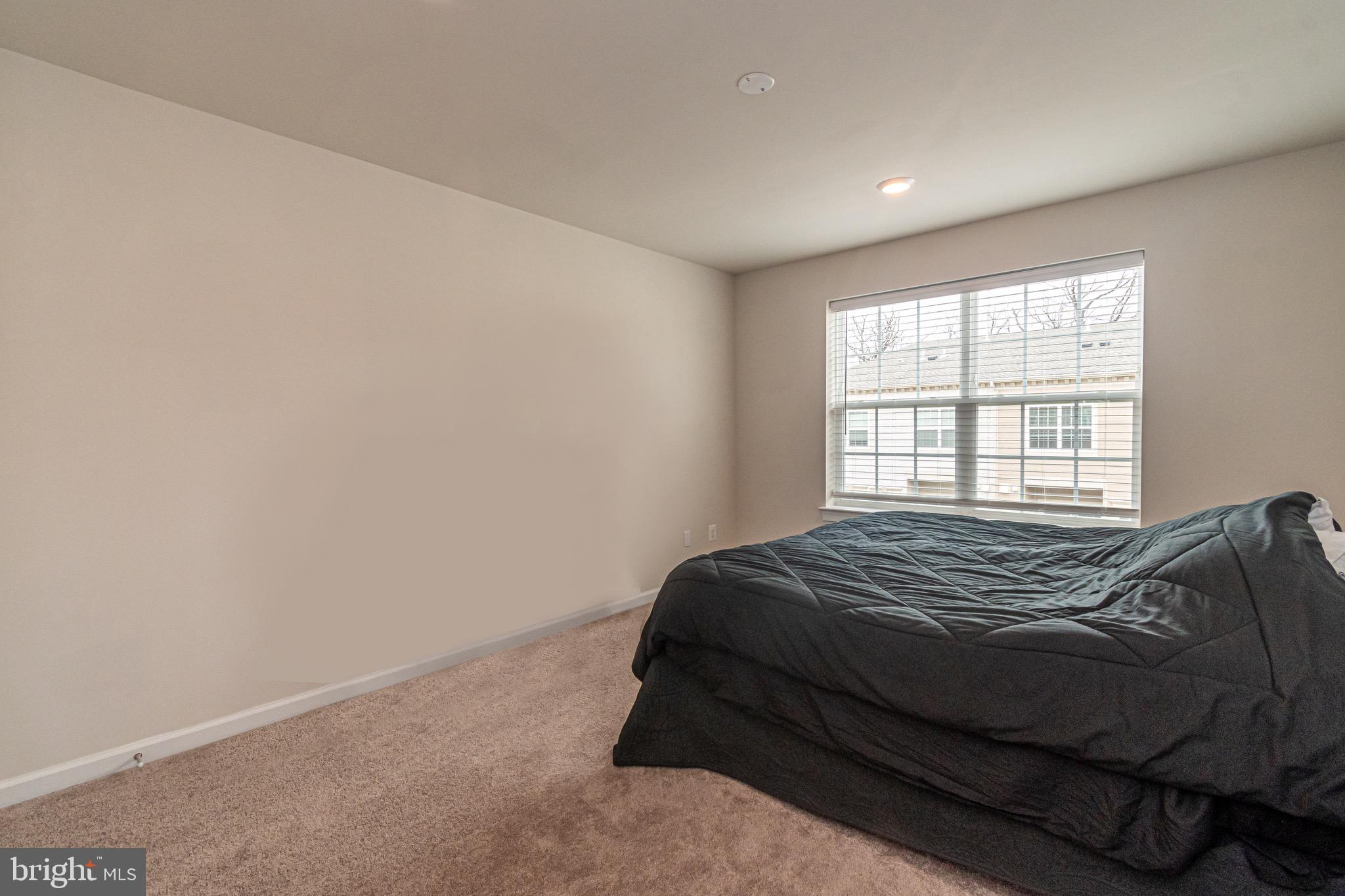 9637 Block Street Lanham, MD 20706 - Photo 32 of 47 a bedroom with a bed and a window