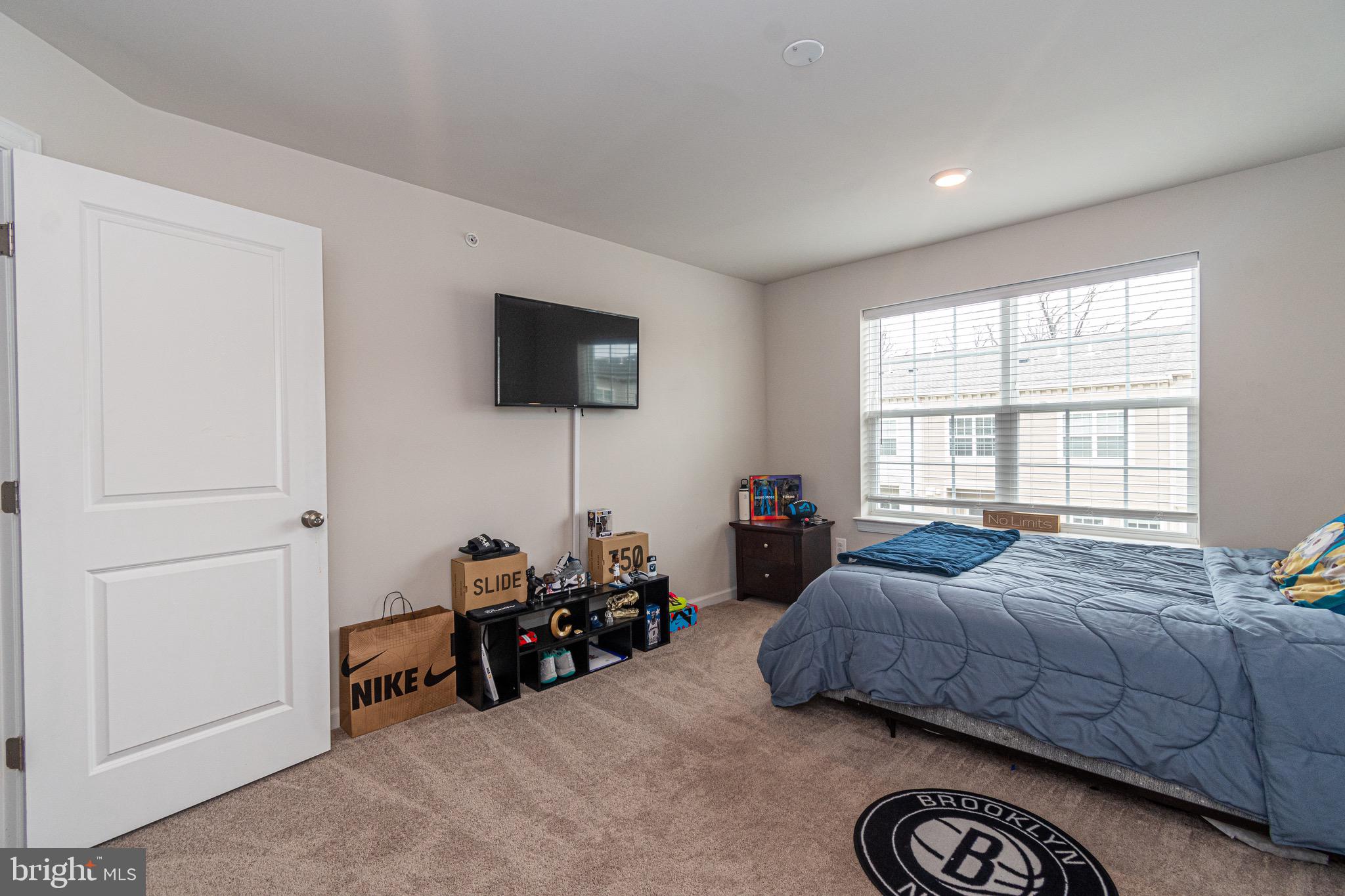 9637 Block Street Lanham, MD 20706 - Photo 37 of 47 a living room with furniture a flat screen tv and a window