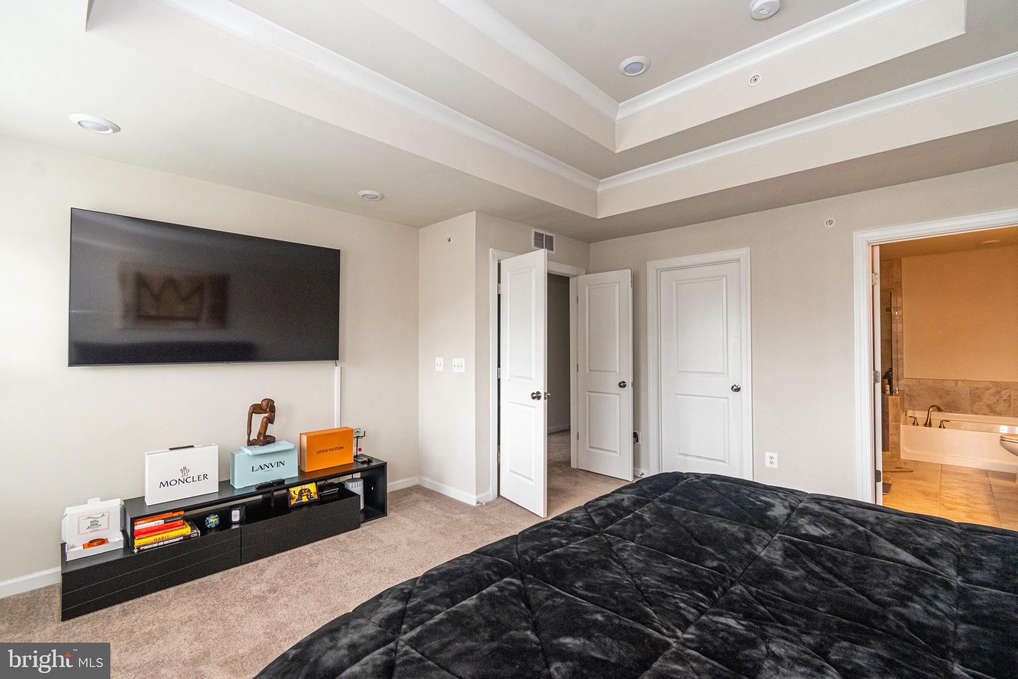 9637 Block Street Lanham, MD 20706 - Photo 38 of 47 a bedroom with a bed and a flat screen tv