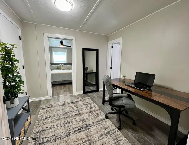 a view of a workspace with furniture and a potted plant