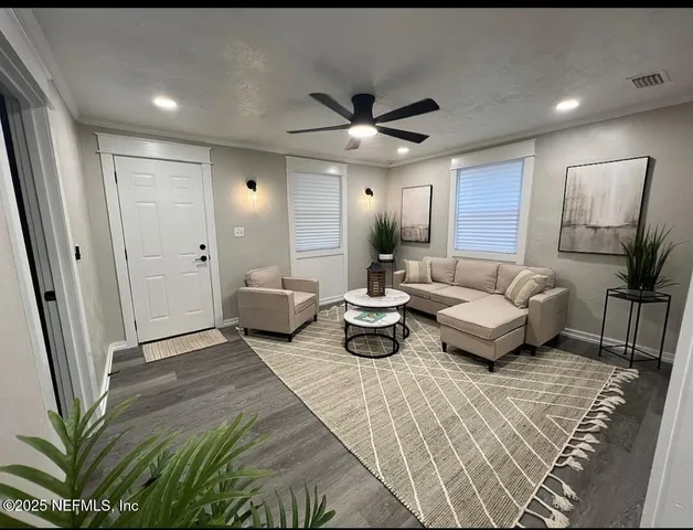 a living room with furniture and a chandelier