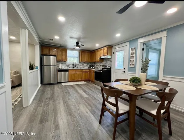 a kitchen with a table and chairs in it