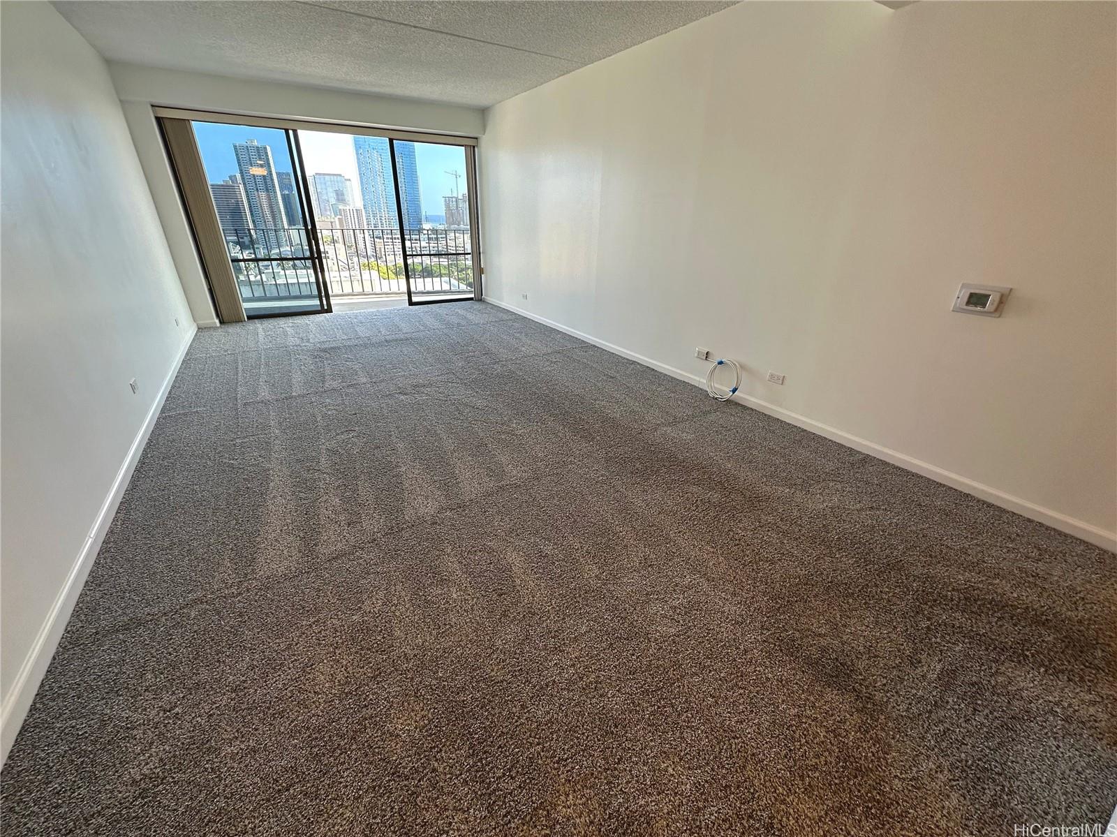 700 Richards Street, Unit 1708 Honolulu, HI 96813 - Photo 1 of 18 an empty room with windows