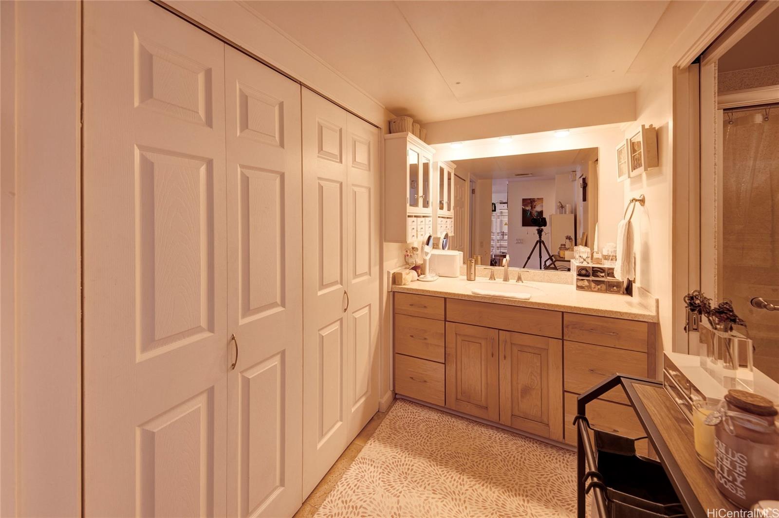 700 Richards Street, Unit 1708 Honolulu, HI 96813 - Photo 13 of 25 a bathroom with a sink a mirror a vanity and a shower
