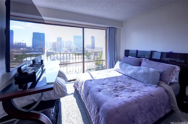 a large bedroom with a bed and glass window