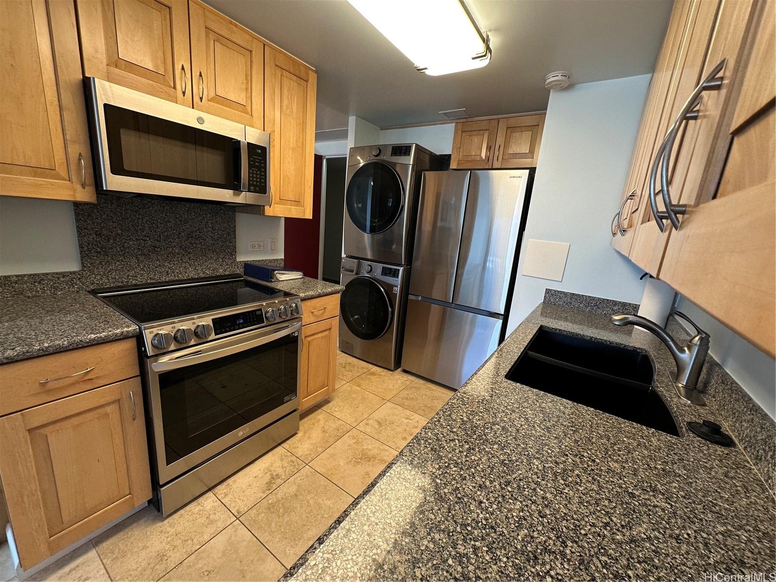 700 Richards Street, Unit 1708 Honolulu, HI 96813 - Photo 2 of 18 a kitchen with granite countertop a refrigerator stove and microwave