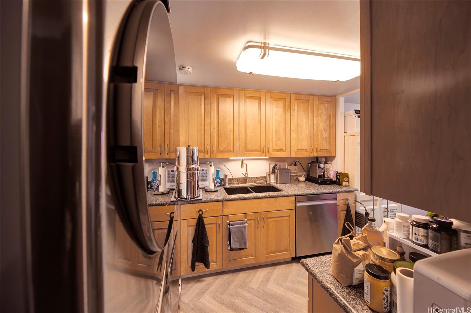 700 Richards Street, Unit 1708 Honolulu, HI 96813 - Photo 3 of 25 a kitchen with stainless steel appliances granite countertop a stove a sink dishwasher and cabinets with wooden floor