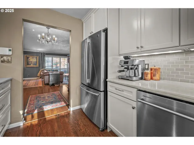 a kitchen with refrigerator and cabinets