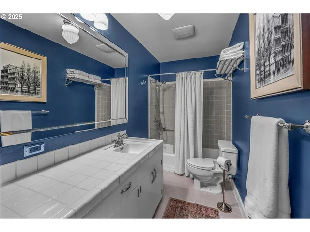 a bathroom with a sink mirror toilet and shower