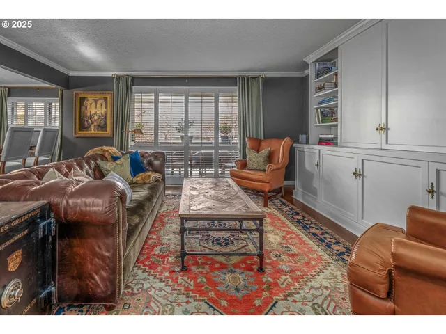 a living room with furniture a flat screen tv and a window