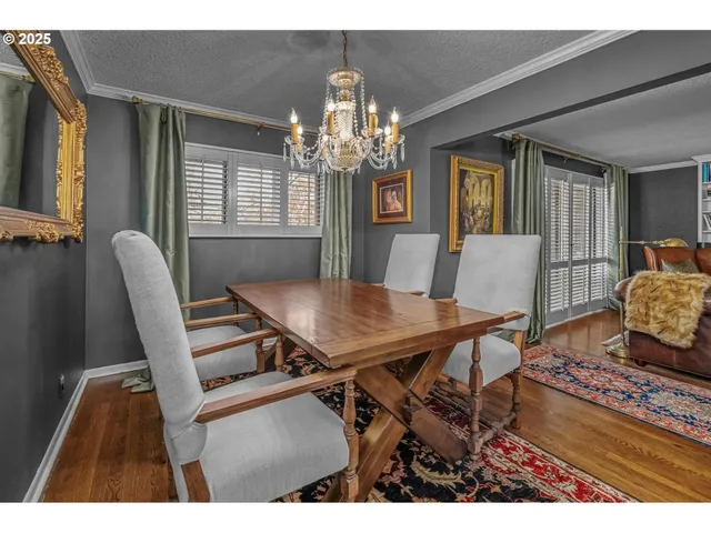 a view of a dining room with furniture and a chandelier