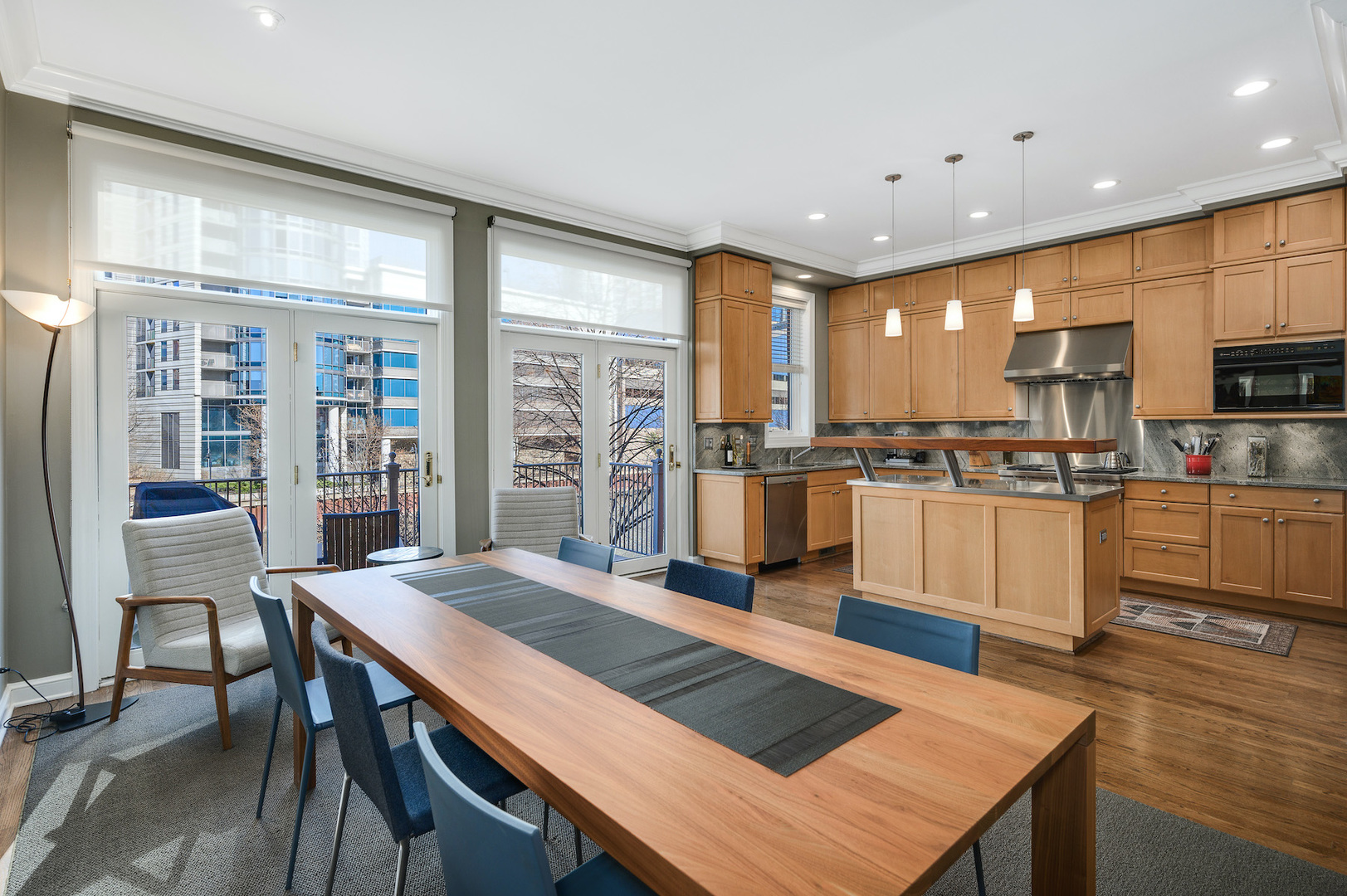 481 North Canal Street Chicago, IL 60654 - Photo 13 of 50 a open kitchen with stainless steel appliances granite countertop a stove top oven a sink a dining table and chairs