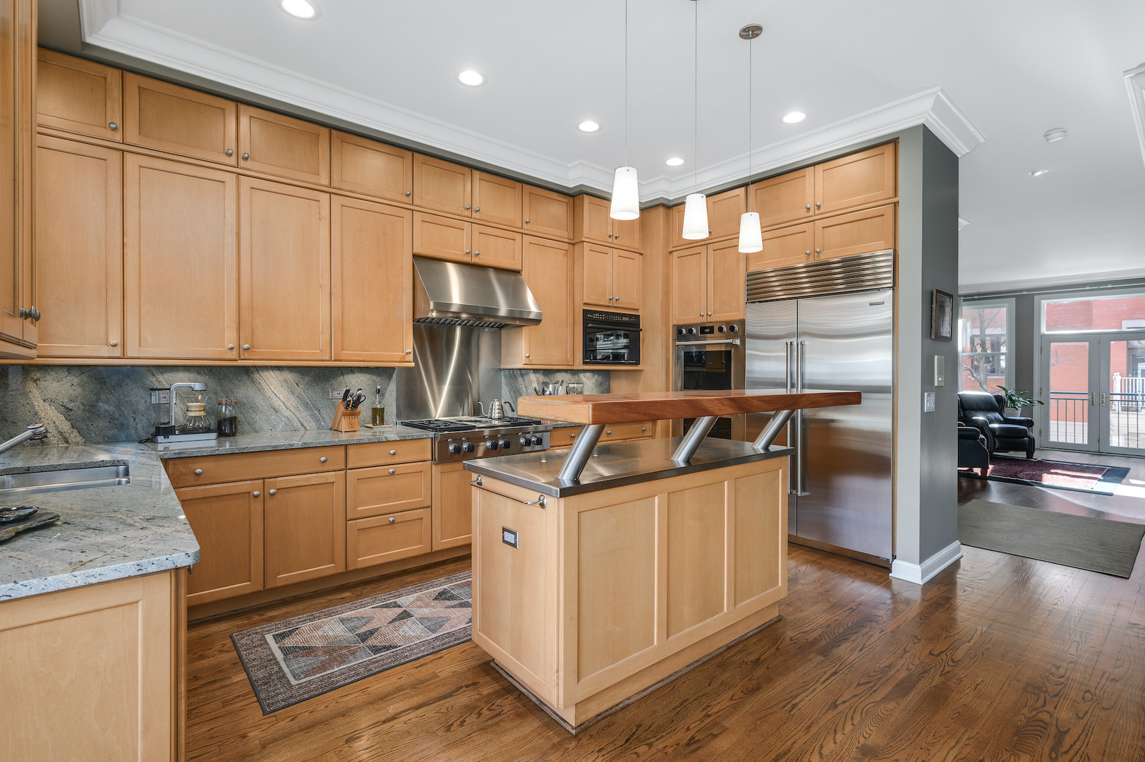 481 North Canal Street Chicago, IL 60654 - Photo 9 of 50 a kitchen with stainless steel appliances granite countertop a stove a sink and a refrigerator