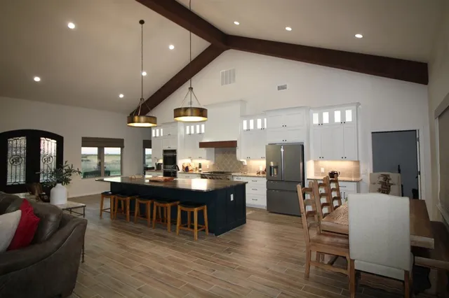 a large kitchen with a table and chairs