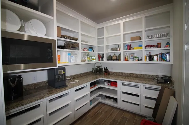 a kitchen with stainless steel appliances a stove and a microwave