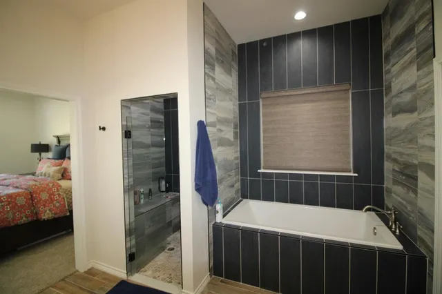 a bathroom with a bathtub and a shower