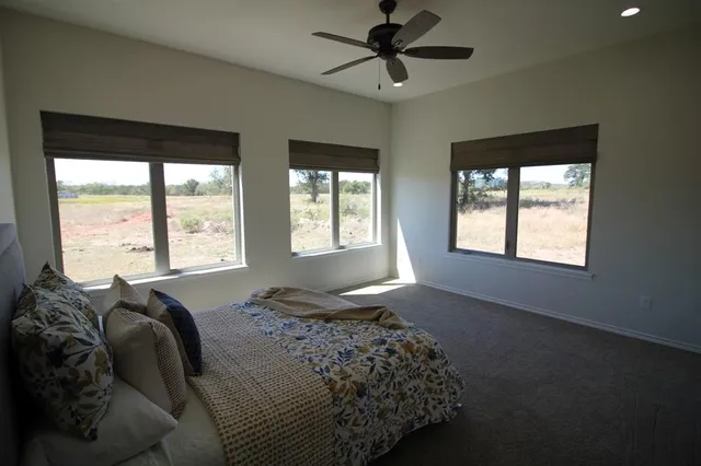 a bed sitting in a bedroom next to a window
