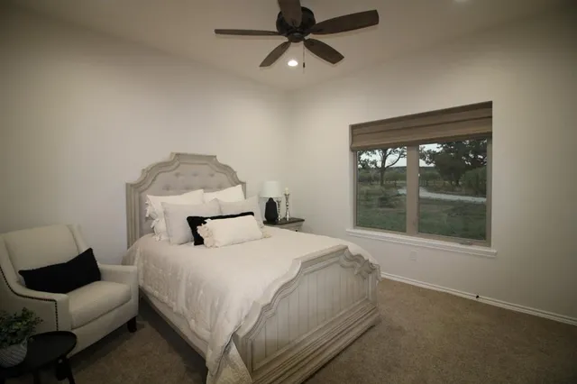 a bedroom with a large bed and a window