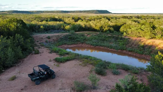 a view of a lake with beach and outdoor space
