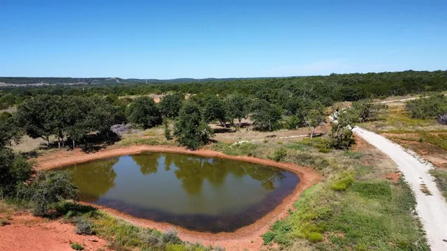 a view of a swimming pool with a yard