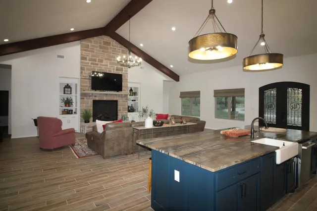 a living room with fireplace furniture and a flat screen tv