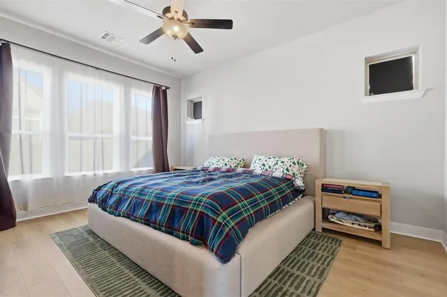 a bedroom with a bed and a chandelier