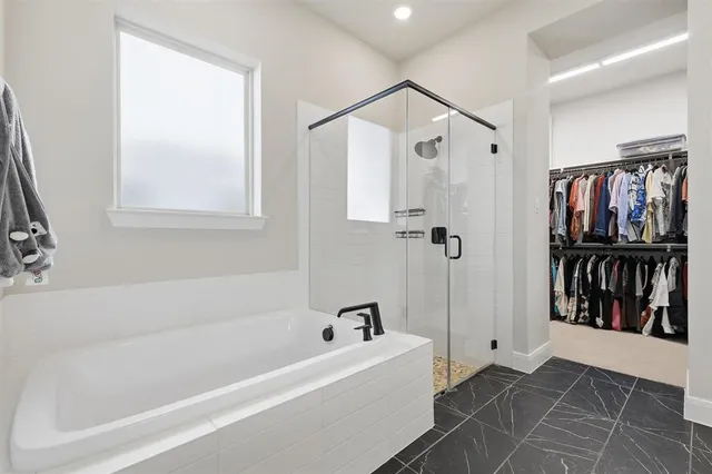 a spacious bathroom with a shower and a sink