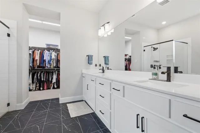 a bathroom with a tub a sink and a shower