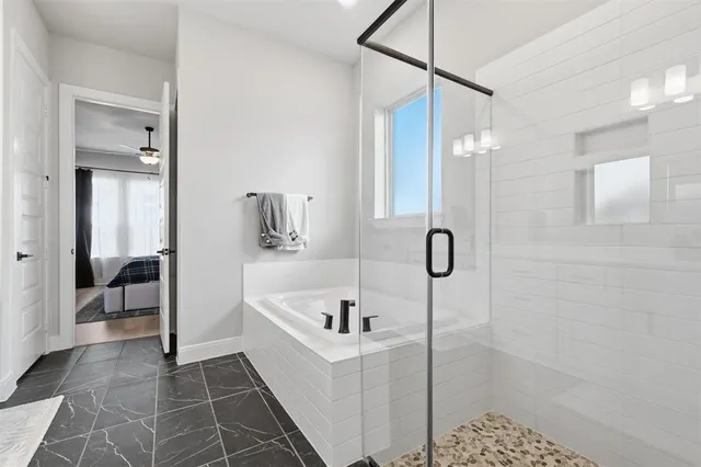 a spacious bathroom with double sink a mirror and a shower