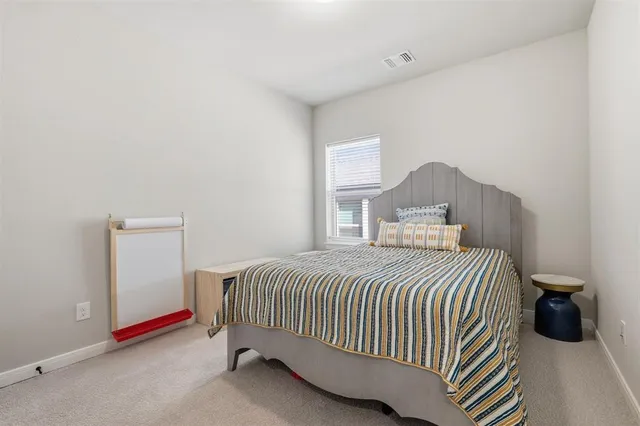 a bedroom with a bed and cabinets