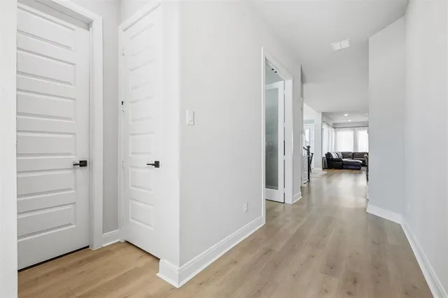 a view of a hallway with wooden floor